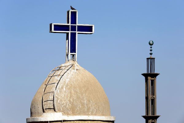 Image Christian cross on a coptic church and cresent on the minaret of a muslim mosque in Upper Egypt