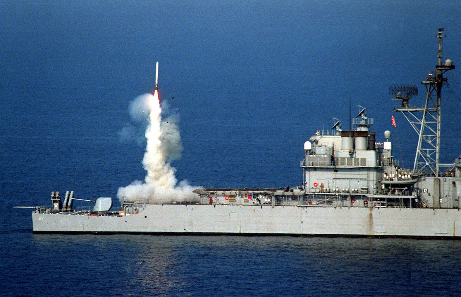 Image A Tomahawk cruise missile launches from the stern vertical launch system of the USS Shiloh (CG 67) to attack selected air defense targets south of the 33rd parallel in Iraq on Sept. 3, 1996, as part of Operation Desert Strike (DoD photo).