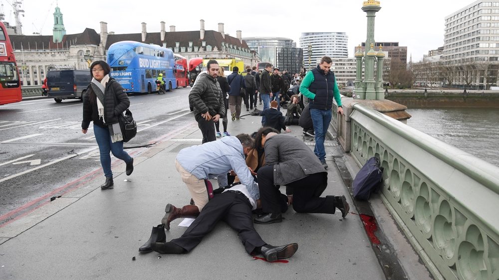 Image Injured people are assisted after the attack on Westminster Bridge [Toby Melville/Reuters]