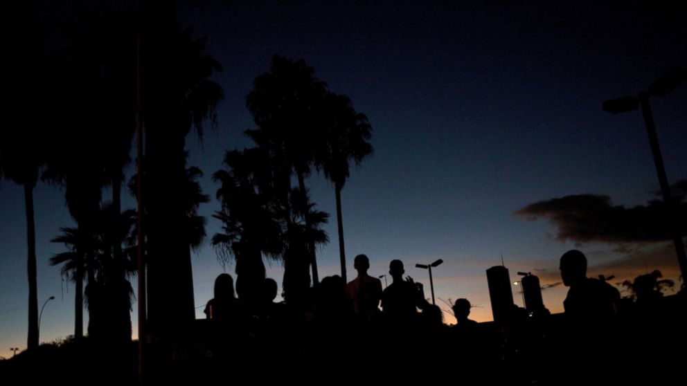 Image A group sings Christmas carols at a dark Venezuela Square in Caracas, Venezuela, Dec. 22, 2017 (AP Photo/Fernando Llano)