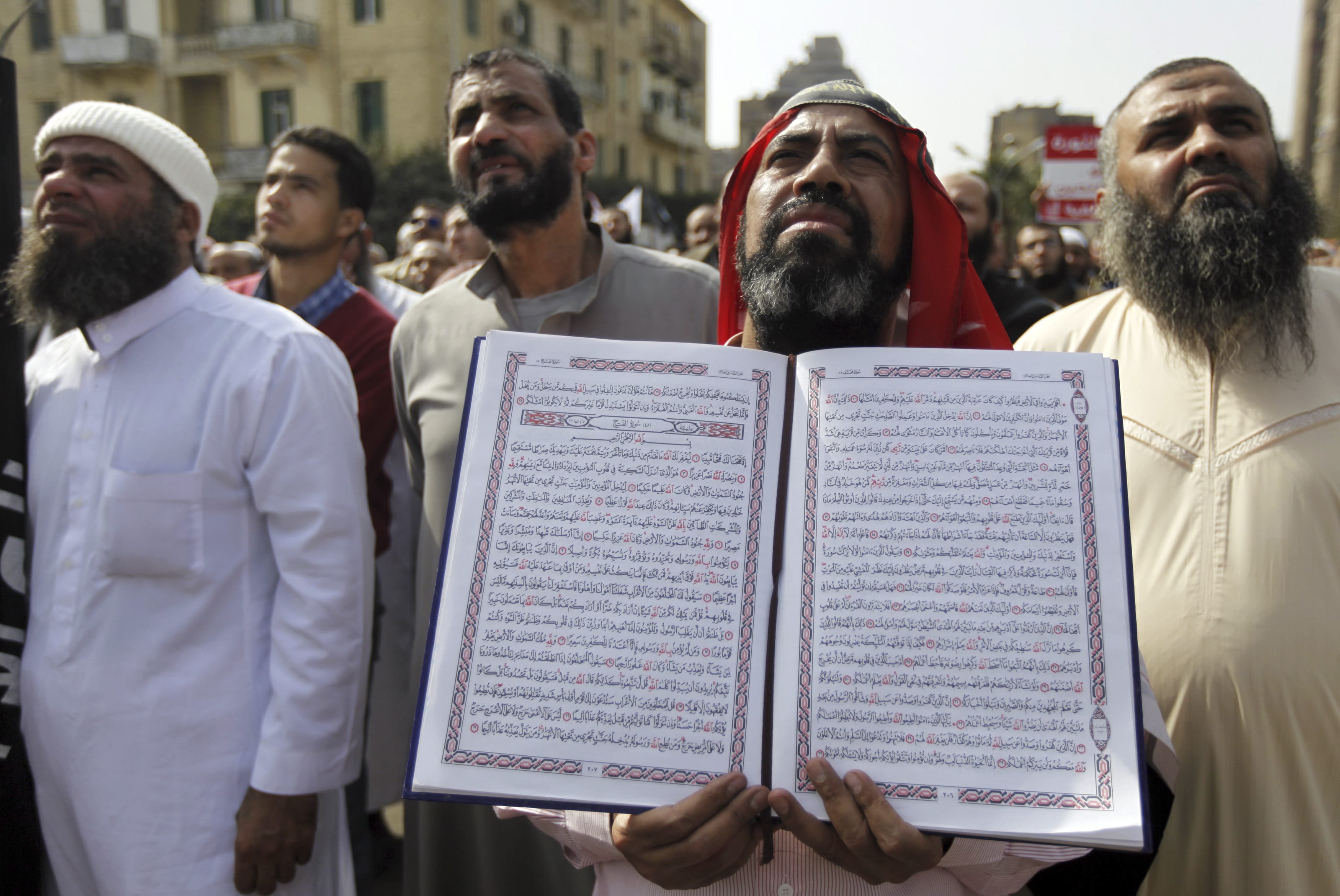 Image An Egyptian Salafi Muslim man holds a copy of the Koran during a protest in support of police officers who were suspended from work because of their beards, Cairo, March 1, 2013 (REUTERS/Amr Abdallah Dalsh).