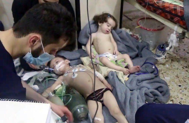 Image A video image provided by the Syrian Civil Defense after a suspected chemical attack in the Damascus suburb of Douma on April 8, 2018 [Image: Syrian Civil Defense White Helmets, via AP]