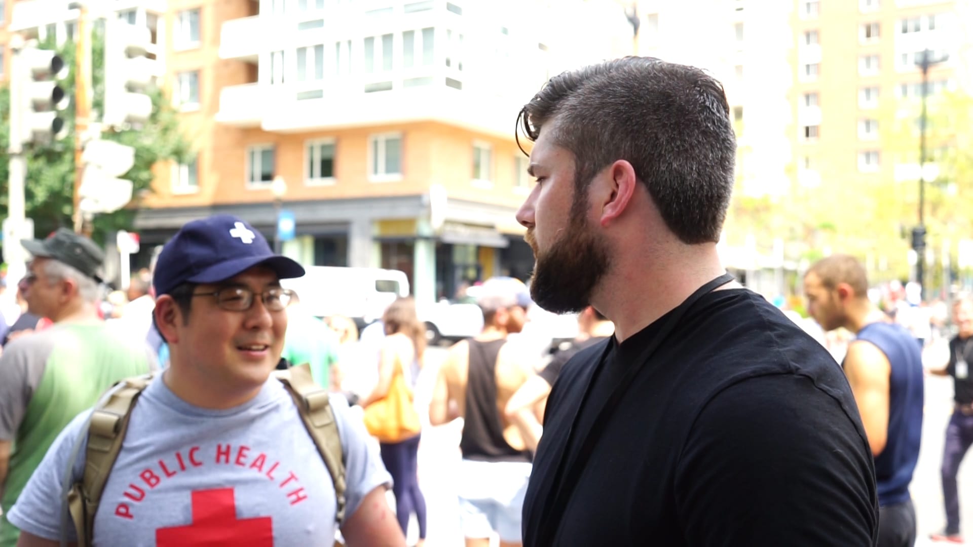 Image [Ando Muneno (l), a former Navy corpsmen and medical specialist speaks with Alex Kish, Lima Charlie News correspondent (r). Mueno came to provide medical aid to anyone in need, regardless of their ideology, at the Unite the Right 2 rally, Washington, D.C., August 12, 2018][Image; Diego Lynch / Lima Charlie News].