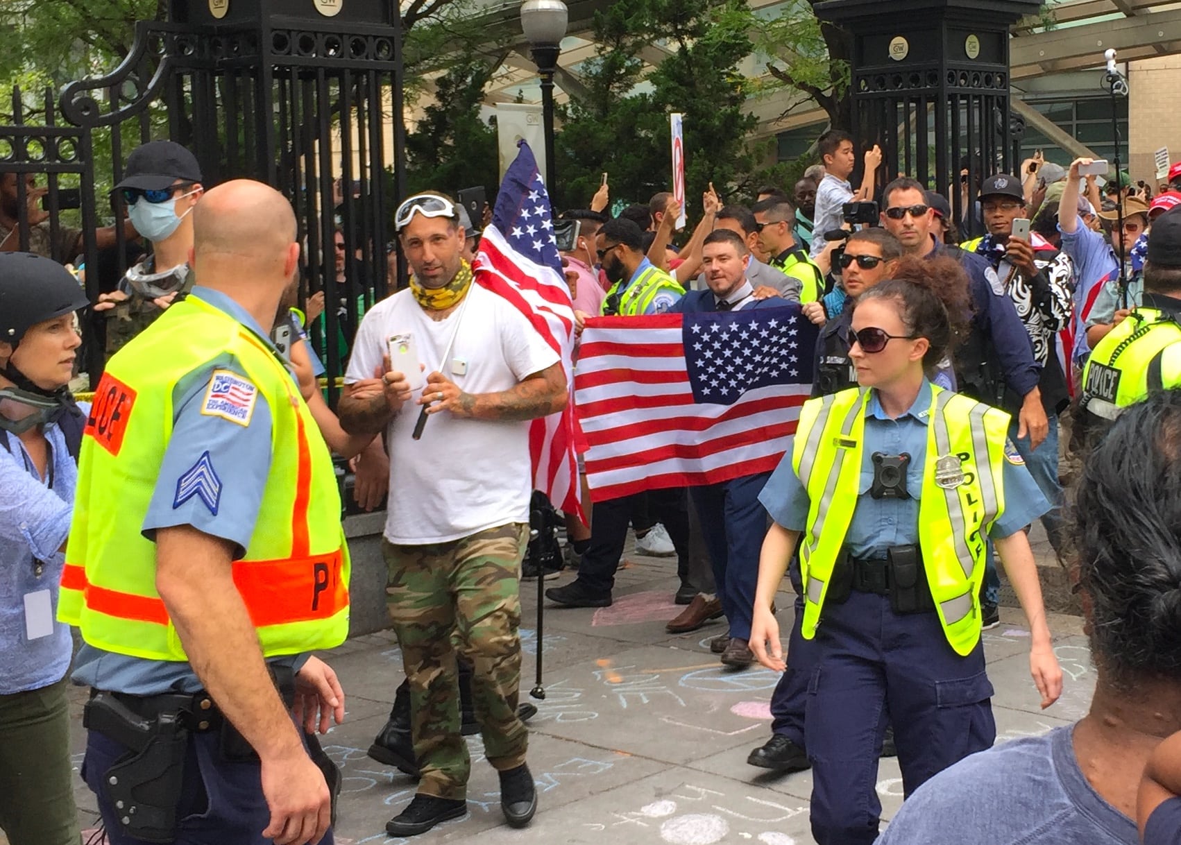 Image [Jason Kessler, Unite the Right organizer, emerges from Foggy Bottom metro station, with supporters, in Washington, D.C., August 12, 2018][Photo: Max Korzen / Lima Charlie News]