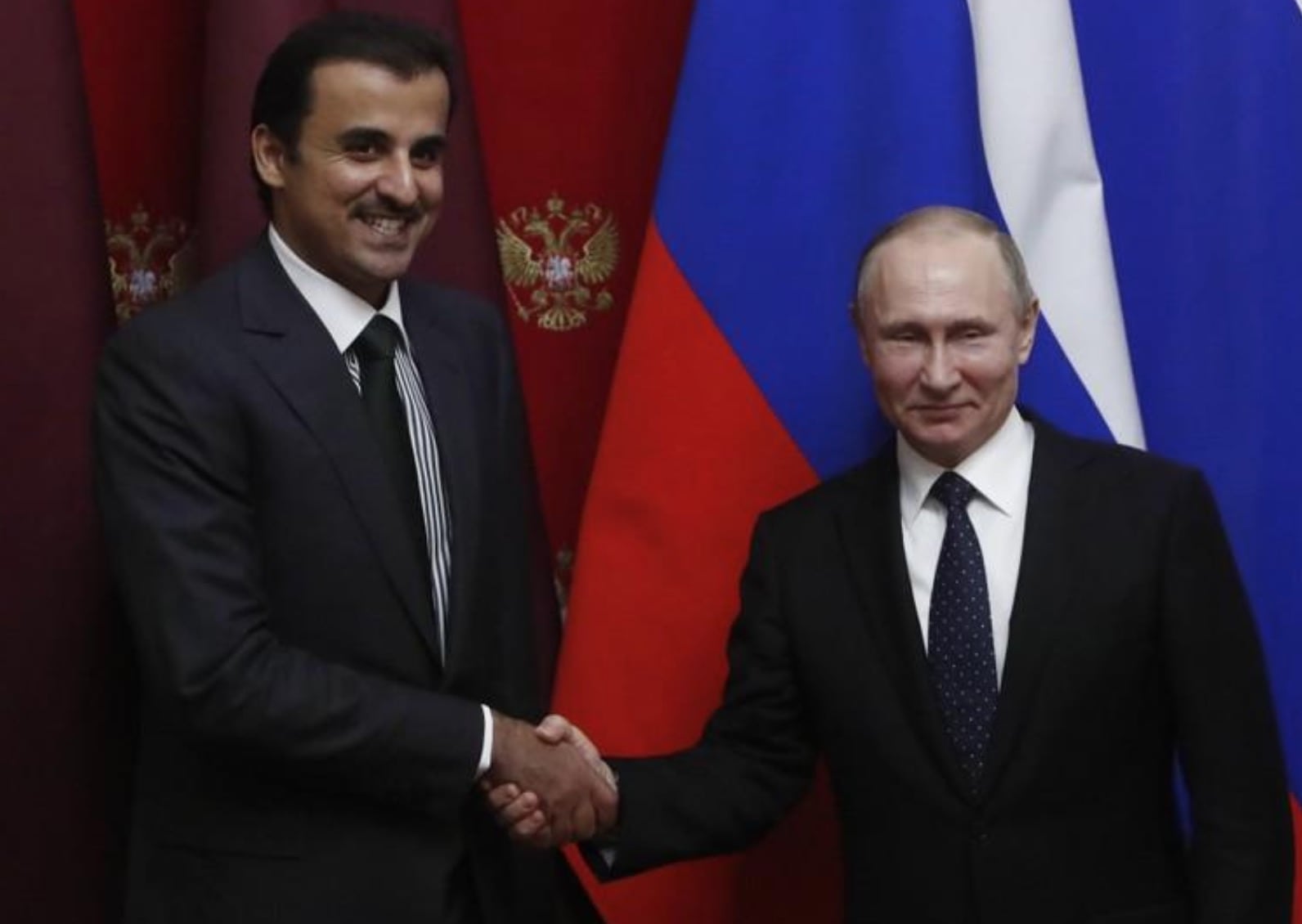 Image Russian President Vladimir Putin and Qatar's Emir Sheikh Tamim bin Hamad al-Thani shake hands during a signing ceremony following a meeting at the Kremlin in Moscow, Russia March 26, 2018. [REUTERS / Sergei Karpukhin]