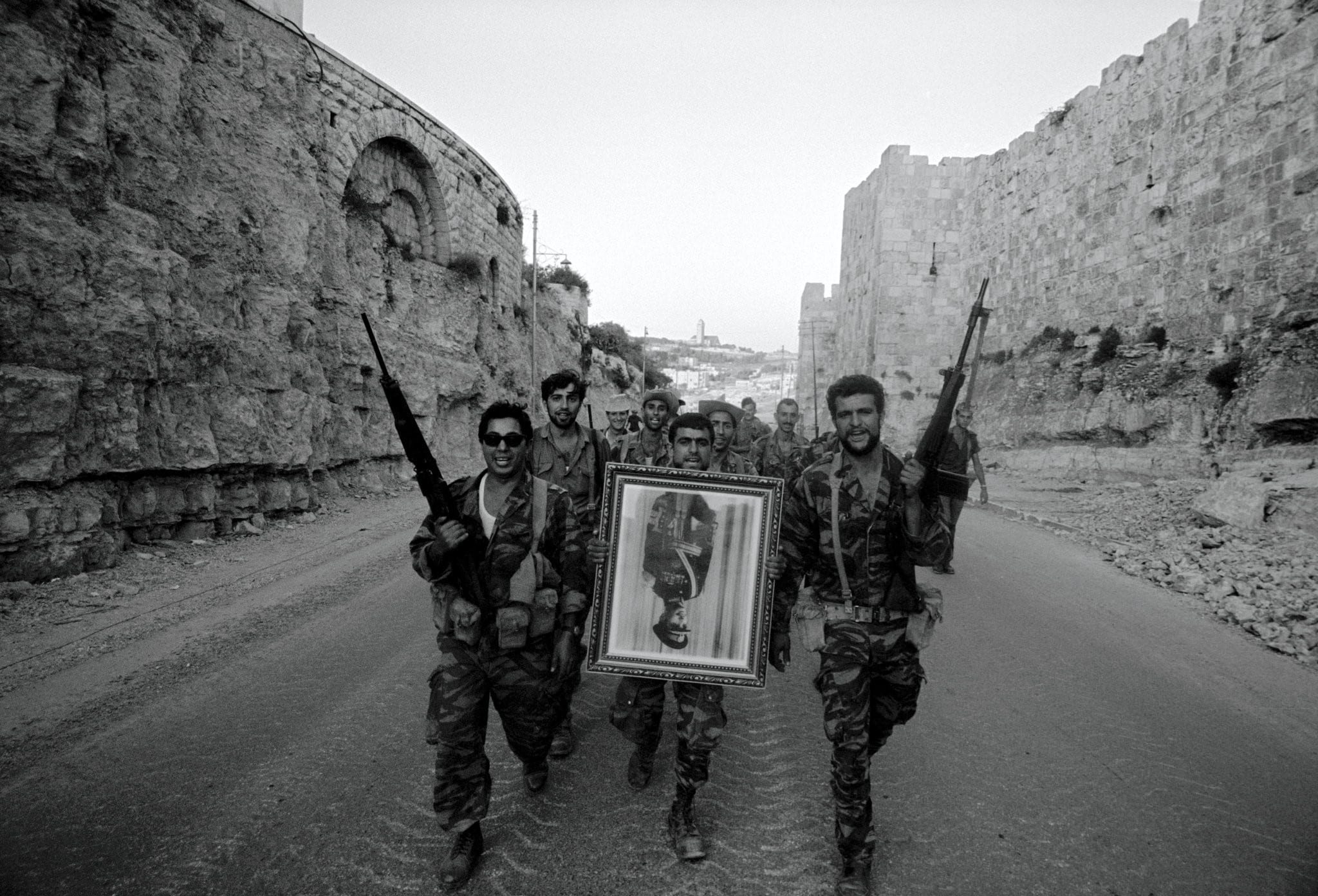 Image [After Israel seized East Jerusalem in 1967, its soldiers carried a confiscated portrait of King Hussein of Jordan. Credit: Leonard Freed / Magnum Photos]