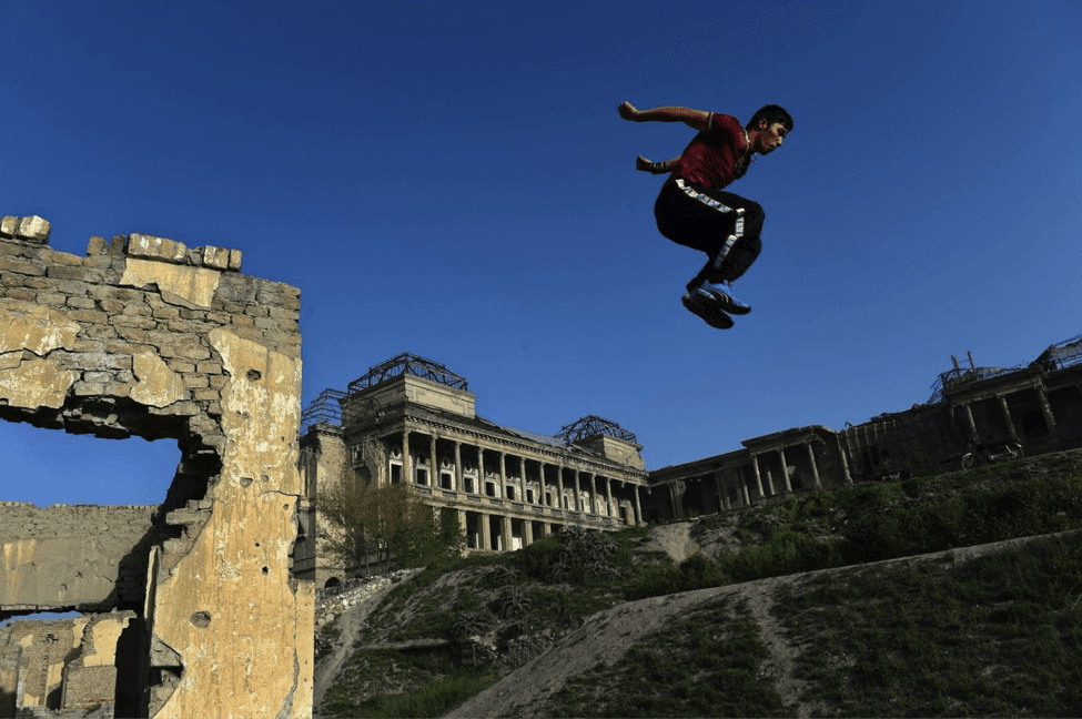 Image An Afghan youth practices his parkour skills in the ruins of Darul Aman Palace. (Image by Wakil Kohsar)