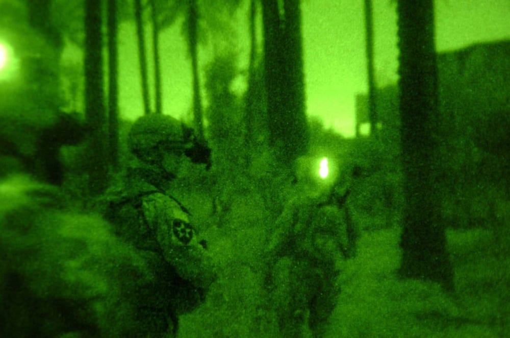 Image [Soldiers move through the outskirts of palm groves in Baqubah, Iraq, during a night mission March 25, 2007][Source: DoD photo courtesy 5th Mobile Public Affairs Detachment (Released)]