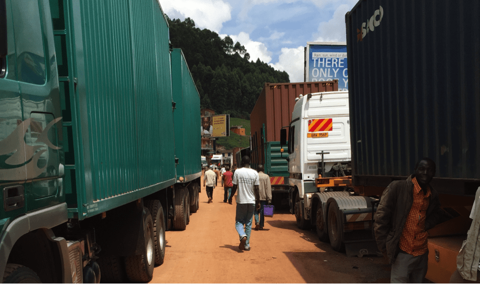 Image [Trucks at the Rwanda/Uganda Border. Uganda impounded Rwandan trucks at this border in November 2018 while transporting minerals worth $750,000. (AmarinAfrica photo via Wikicommons)]